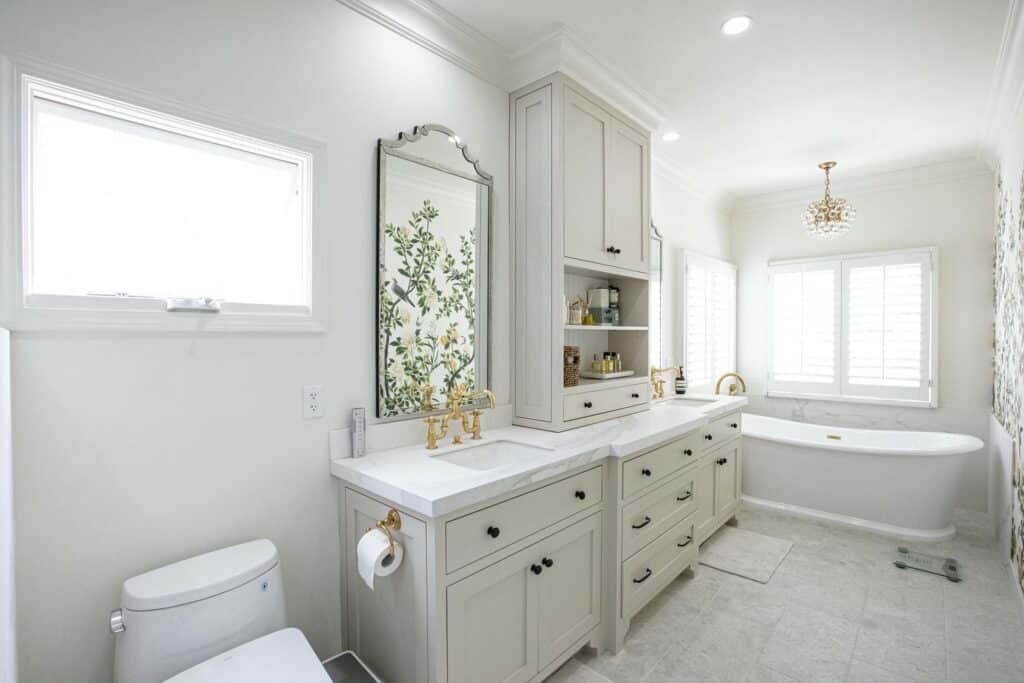 White bathroom cabinetry, floral wallcovering and freestanding tub on 7th Street