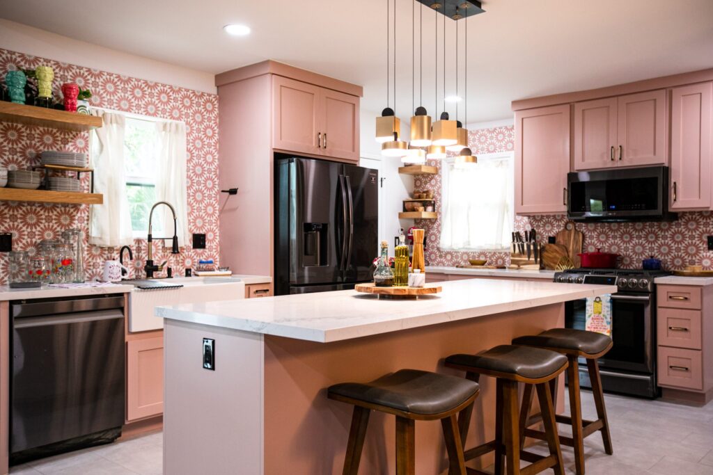 Pink kitchen remodel with patterned backsplash and island seating