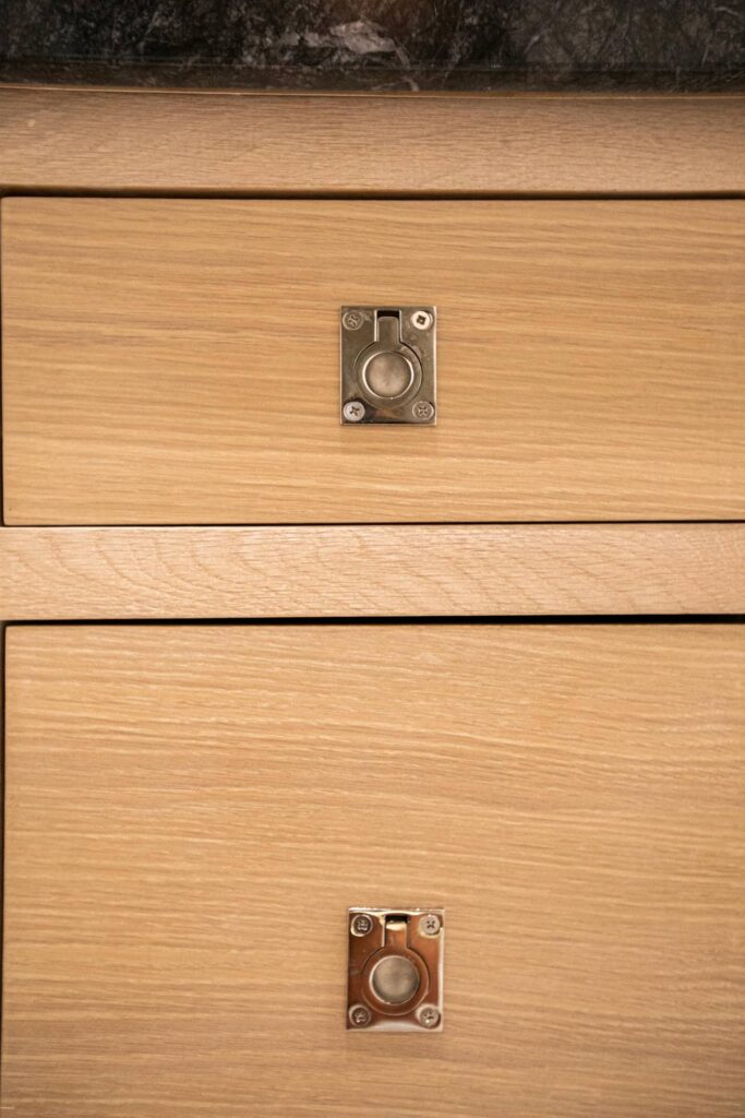Wood vanity drawer fronts and metal pulls at Zelzah Avenue