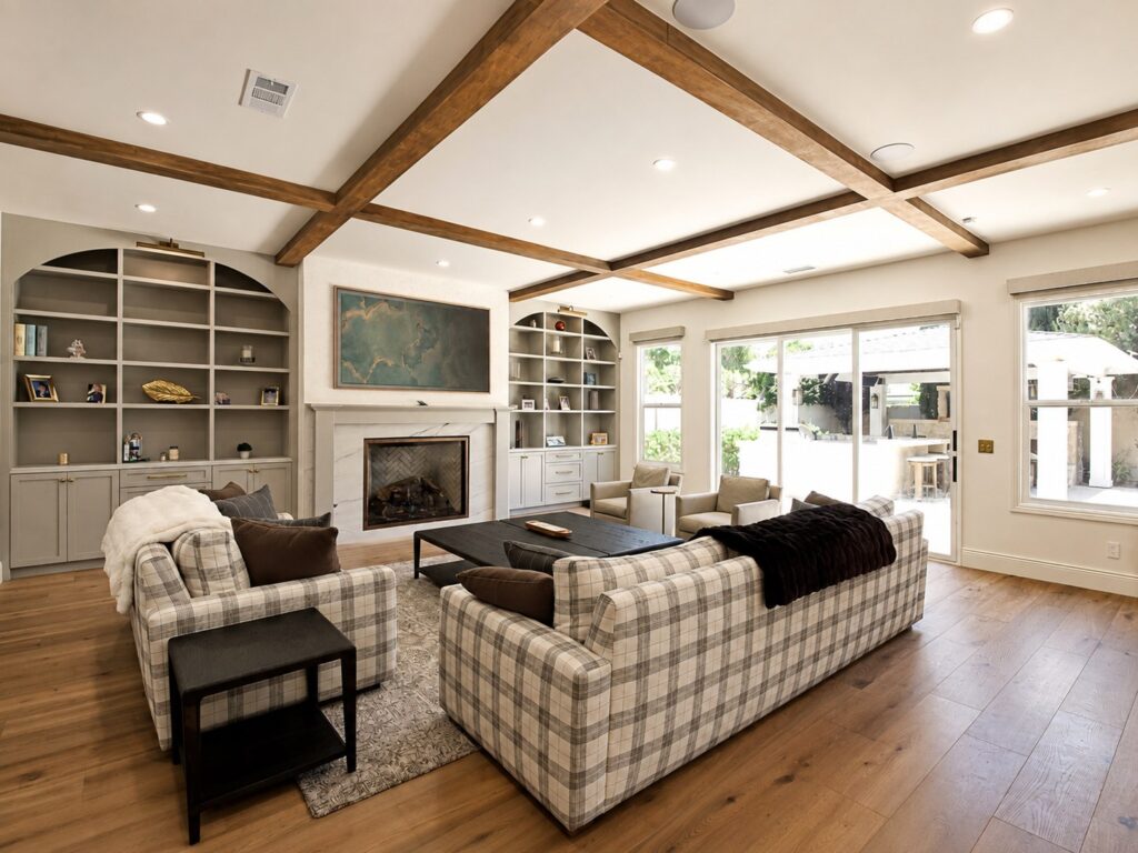 Living room with ceiling beams and built-in shelving in the Loch Lomond home renovation
